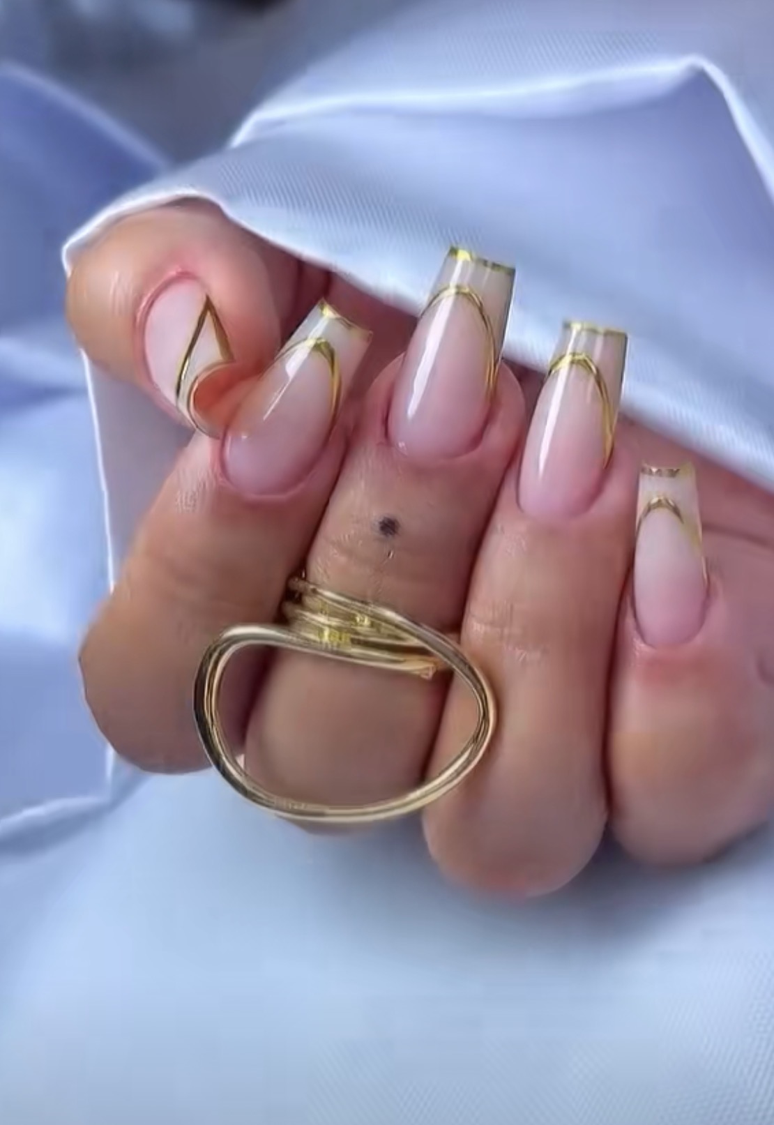 Elegant gold French tip manicure at Nefis Beauty Spa Salon